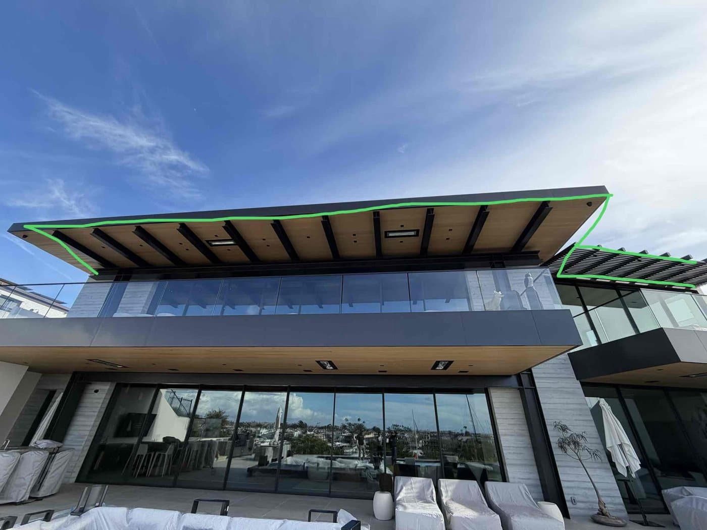 Design markup along the eaves of a modern glass home